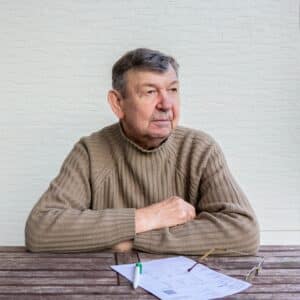 Portrait of elderly man sitting at table